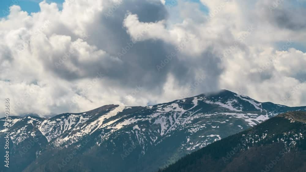 Dramatic heavy clouds sky motion over alpine mountains in early spring season Nature Time lapse Dramatic heavy clouds sky motion over alpine mountains in early spring season Nature Time lapse