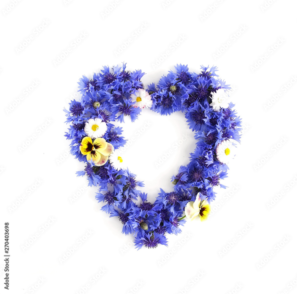 Wreath, frame, a circle in heart form from blue flowers cornflowers and pansy flowers  pattern on white background. top view. copy space