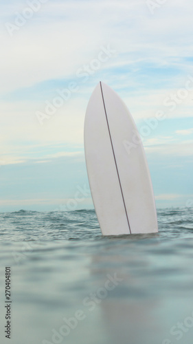 surfboard in ocean © Matheus