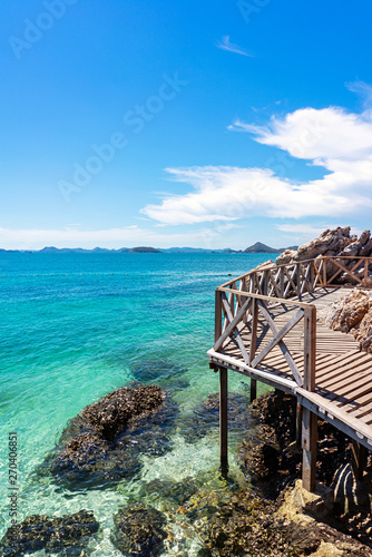 Wooden platform with clear turquoise sea and blue sky