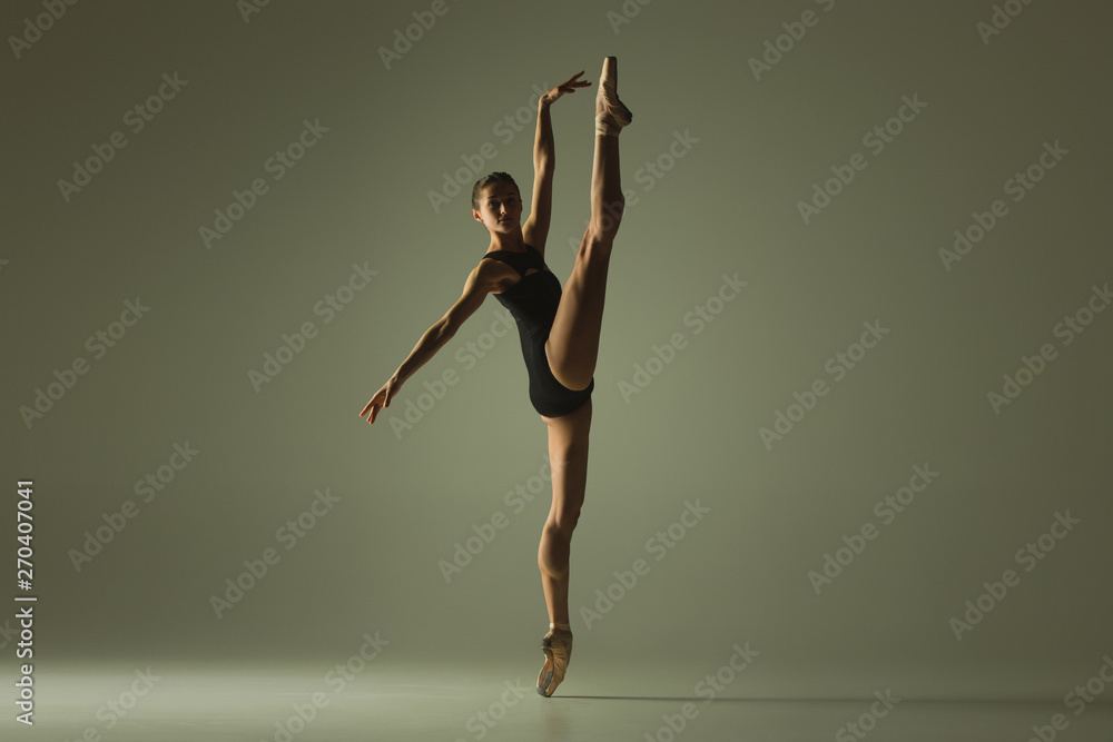 Graceful ballet dancer or classic ballerina dancing isolated on grey studio background. Showing flexibility and grace. The dance, artist, contemporary, movement, action and motion concept.