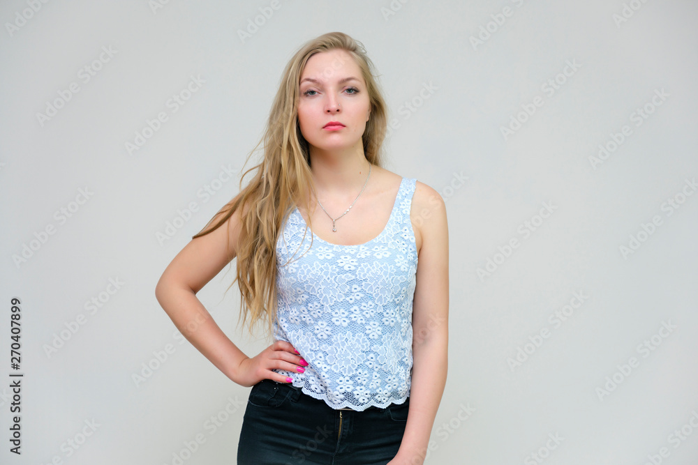 Life is beautiful and I like everything here. I am satisfied with life and I wish you. Portrait of a smiling beautiful blonde girl on a gray background in various poses. Life is beautiful and I like everything here. I am satisfied with life and I wish you. Portrait of a smiling beautiful blonde girl on a gray background in various poses.