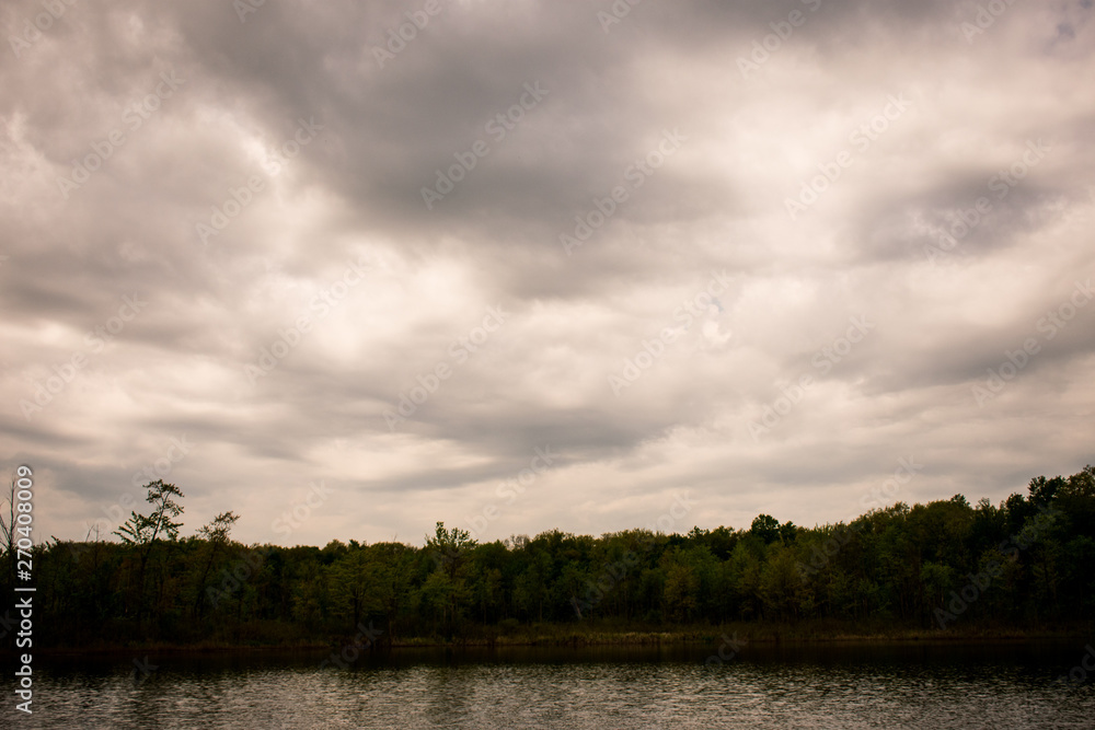 a landscape with water and cloudy sky