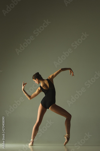 Wallpaper Mural Graceful ballet dancer or classic ballerina dancing isolated on grey studio background. Showing flexibility and grace. The dance, artist, contemporary, movement, action and motion concept. Torontodigital.ca