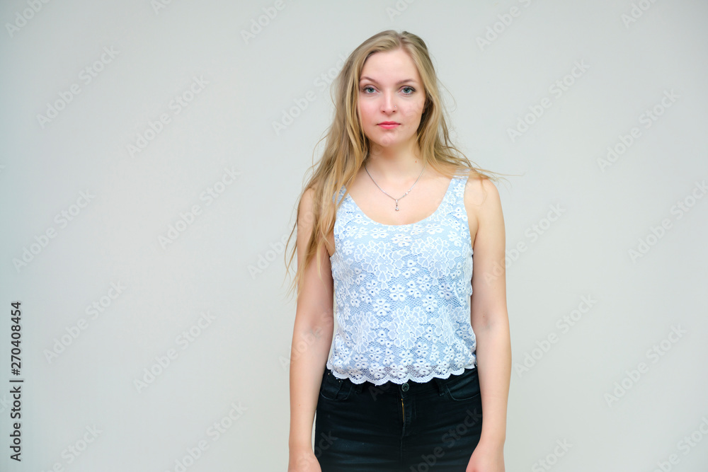 Life is beautiful and I like everything here. I am satisfied with life and I wish you. Portrait of a smiling beautiful blonde girl on a gray background in various poses. Life is beautiful and I like everything here. I am satisfied with life and I wish you. Portrait of a smiling beautiful blonde girl on a gray background in various poses.