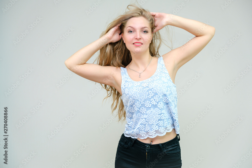 Life is beautiful and I like everything here. I am satisfied with life and I wish you. Portrait of a smiling beautiful blonde girl on a gray background in various poses. Life is beautiful and I like everything here. I am satisfied with life and I wish you. Portrait of a smiling beautiful blonde girl on a gray background in various poses.