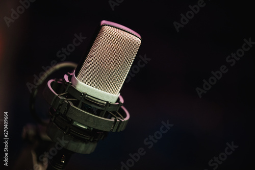 Microphone on stage against a background of auditorium.