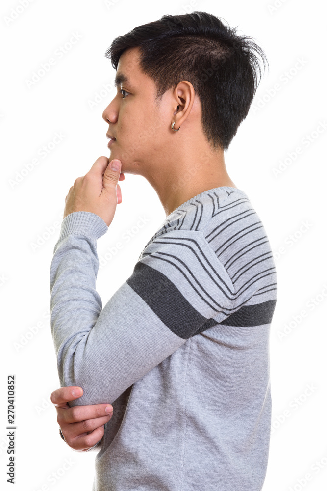 Profile view of handsome Asian man thinking Profile view of handsome Asian man thinking