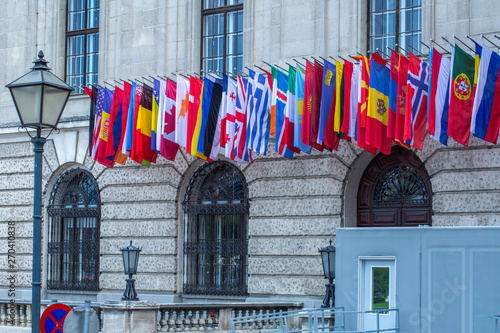 Flags of almost all countries of the northern hemisphere on the facade the building of Hofburg palace in Vienna, Austria. photo