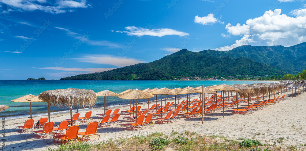 Sunbeds and umbrella on amazing Golden Beach at Thassos, Aegean Sea, Greece