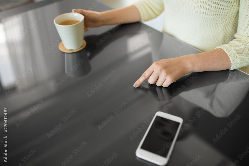 technology and people concept - close up of woman using black interactive panel and drinking coffee