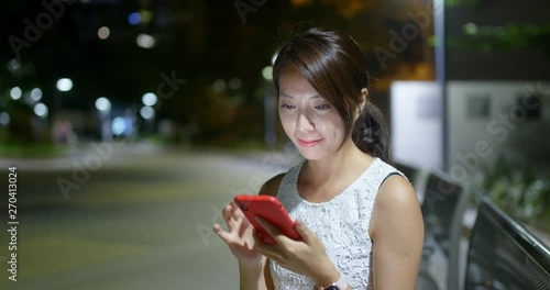 Wallpaper Mural Woman use of mobile phone in city at night Torontodigital.ca