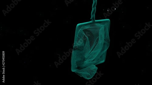 Scoop-net floating under transparent water on black background. Hoop-net in aquarium.  Slow Motion. Close-up. photo