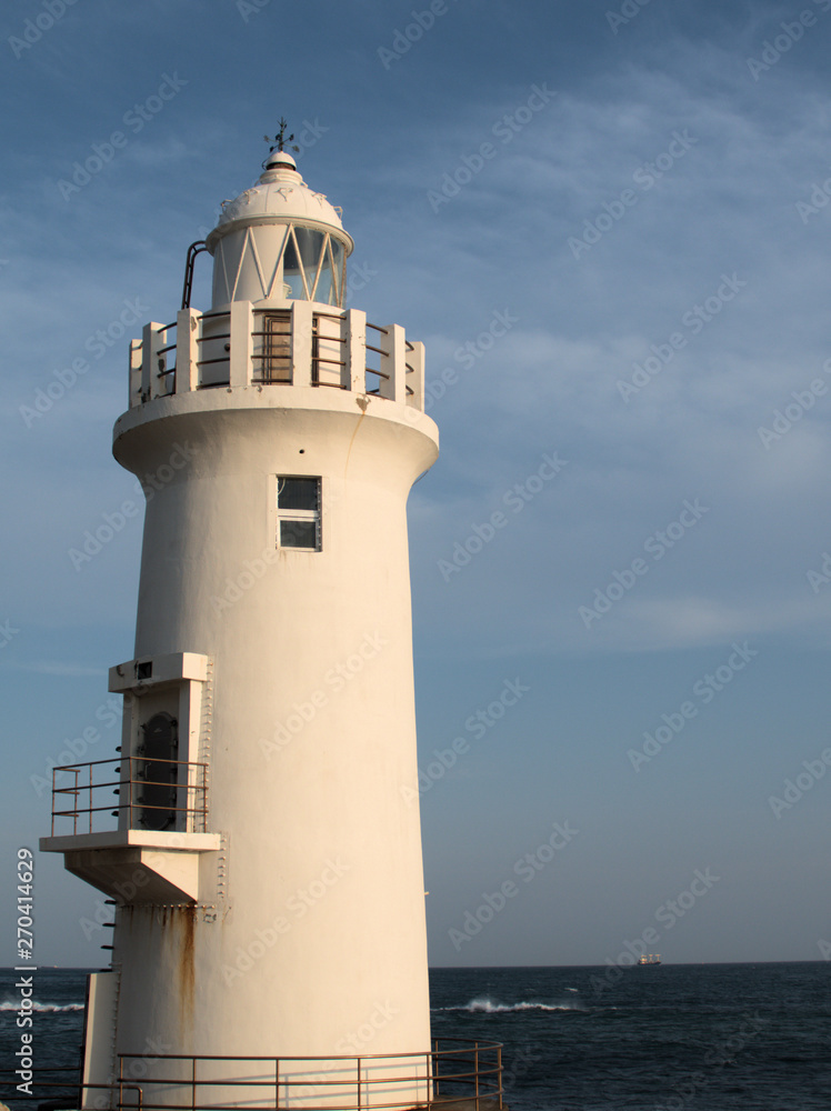 lighthouse with blue sky background in summer