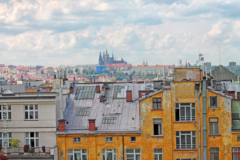 Old roofs in the Prague with view of St. Vitus Cathedral. Czech Republic.