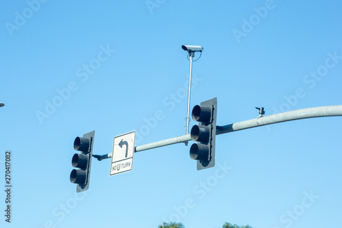 A traffic camera mountaed on top of a street light signal photo