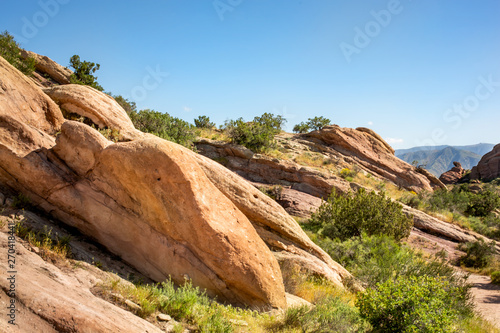Red Rocky terrain and dry brush at Vasquez Rocks Natural Area Park in Agua Dulce