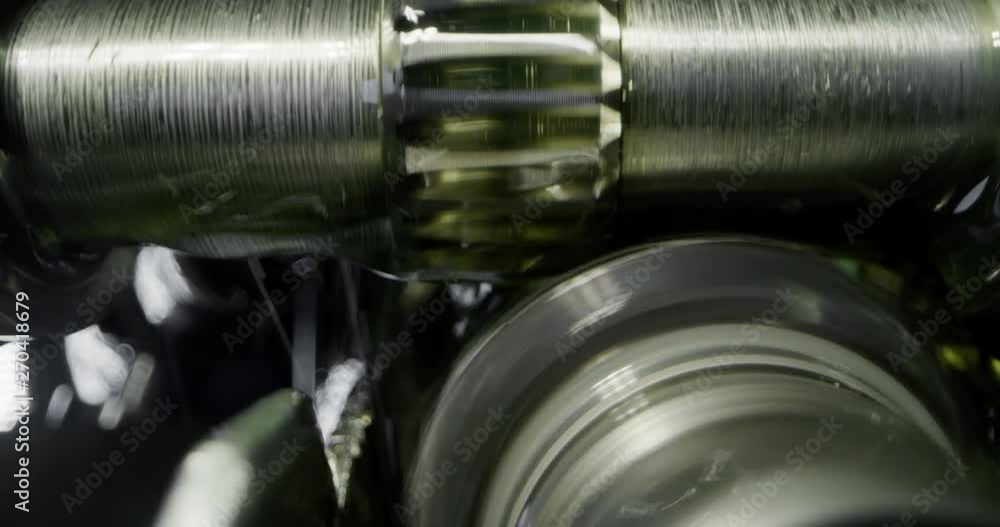 Slow motion macro of specialist is working on production of different gearing details in a workshop in industrial factory. Slow motion macro of specialist is working on production of different gearing details in a workshop in industrial factory.