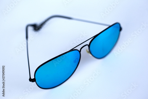 Blue mirrored sunglasses with anti-reflective coating and UV protection on a white background.  photo