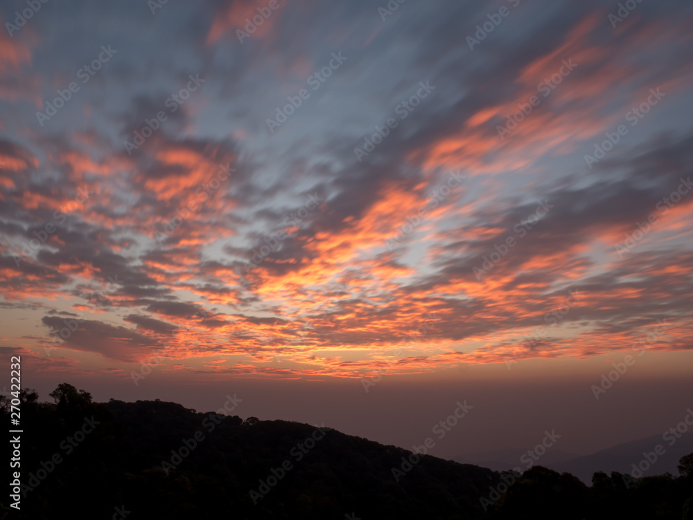 Fototapeta premium Golden light of the morning sunrise, reflected with clouds.