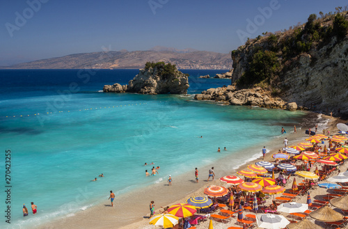 Fototapeta Naklejka Na Ścianę i Meble -  Albania, ksamil -14 July 2018. Tourists are resting on the beach of the Ionian Sea.