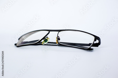 glasses for the visually impaired, poorly sighted.glasses with aspherical astigmatic lenses in black frame on a white background.