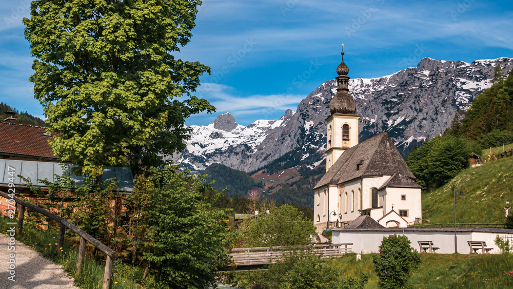The famous church Saint Sebastian with the alps in the background at Ramsau - Bavaria - Germany
