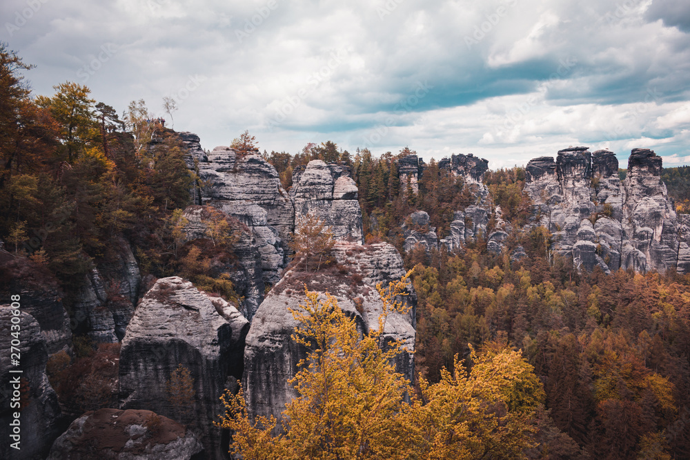View of Sandstone Rocks in Saxon Switzerland National Park, Germany. Mountains, green trees. Spring or summer season. Nature theme.