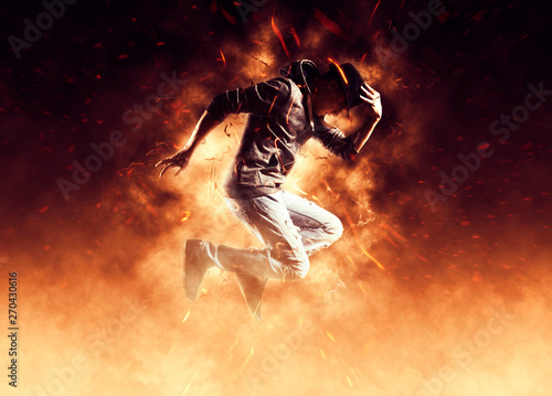 Man break dancing on fire background © Andrey Burmakin