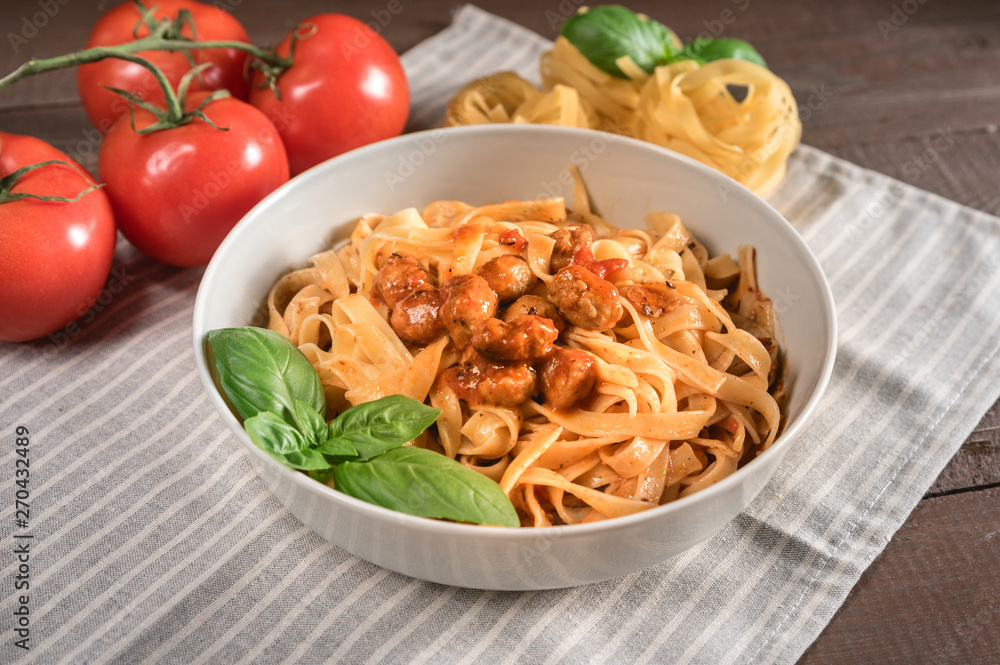 Italian spaghetti and meatballs topped with fresh basil Italian spaghetti and meatballs topped with fresh basil
