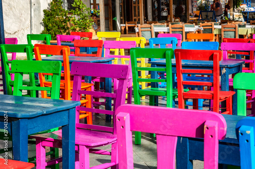 Bright colored wooden chairs in an outdoor cafe