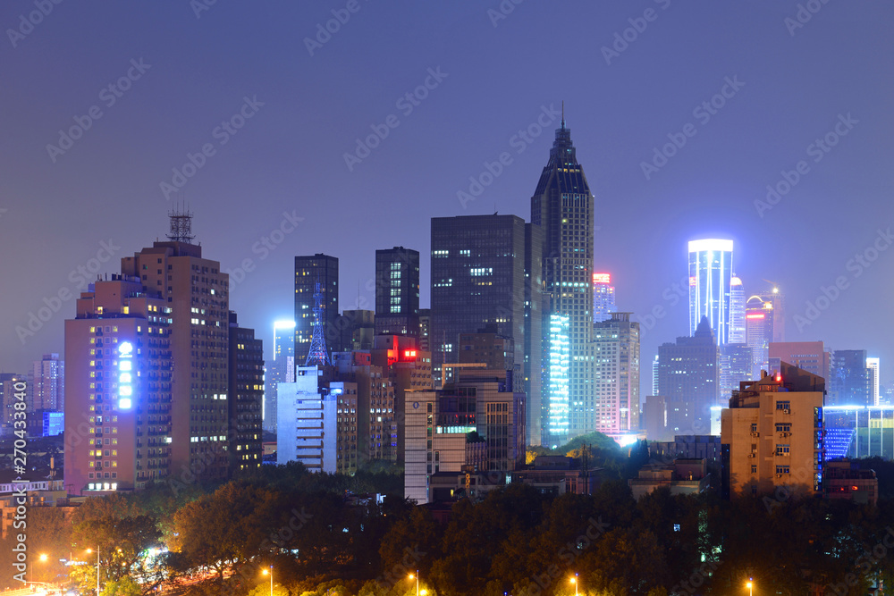 Nanjing Daxinggong CBD with the New Century Plaza Tower at the center at night in downtown Nanjing, Jiangsu Province, China.