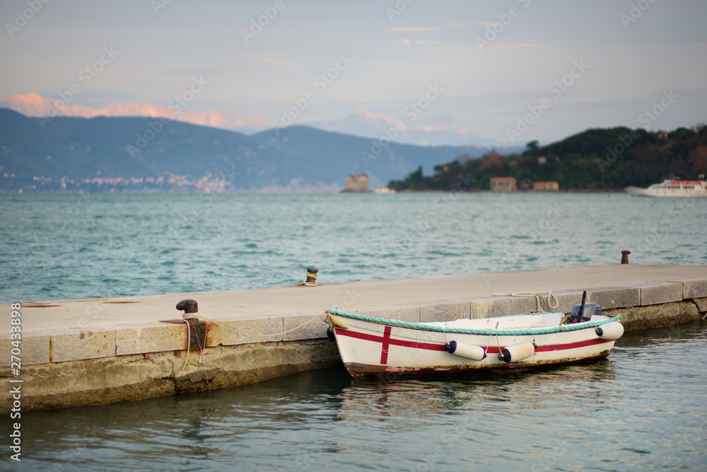 Lonely fishing boat in marina of Porto Venere town, a part of the Italian Riviera, Italy.