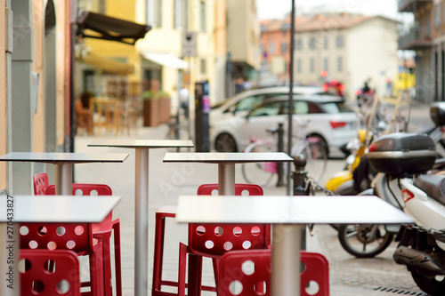 Empty small outdoor restaurant tables in the city of Bergamo, Italy