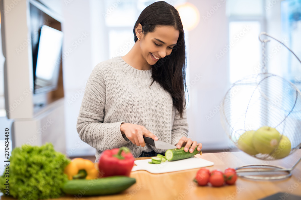 Beautiful woman cooking healthy food in the kitchen