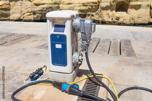 Electricity supply pedestal in a marina in port, stationary power.