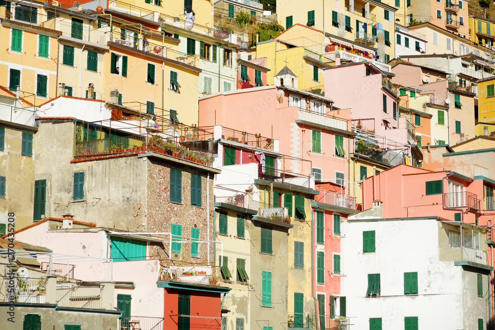 Pastel houses of Riomaggiore, the largest of the five centuries-old villages of Cinque Terre, Italian Riviera, Liguria, Italy.