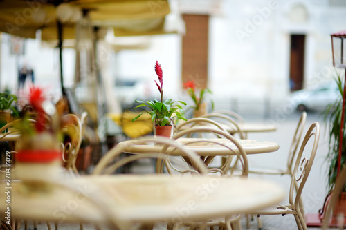Fototapeta Naklejka Na Ścianę i Meble -  Beautifully decorated small outdoor restaurant tables in the city of Lucca, Italy
