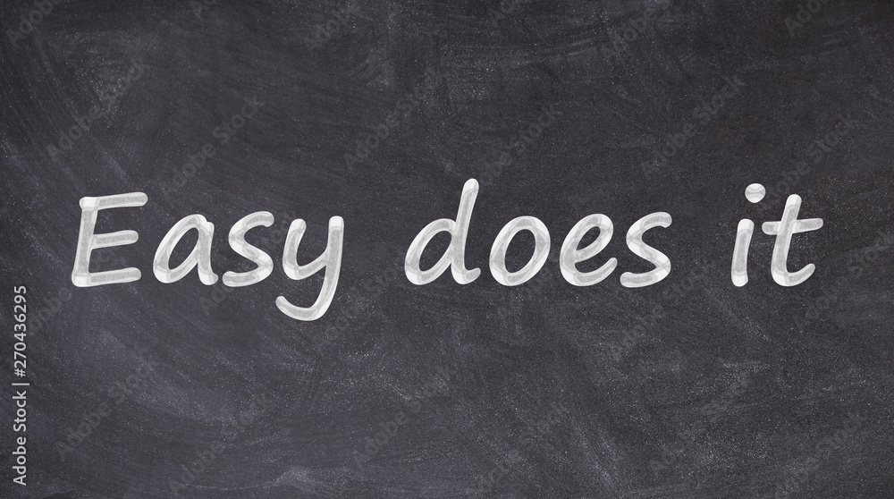Fototapeta premium Easy does it written on blackboard