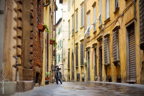 Bicycles parked on beautiful medieval streets of Lucca city, Tuscany, Italy.