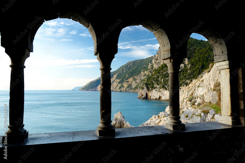 Columns of famous gothic Church of St. Peter with beautiful shoreline scenery in Porto Venere village, Liguria, Italy
