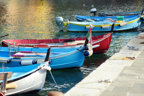 Colourful fishing boats in small marina of Vernazza, one of the five centuries-old villages of Cinque Terre, located on rugged northwest coast of Italian Riviera.