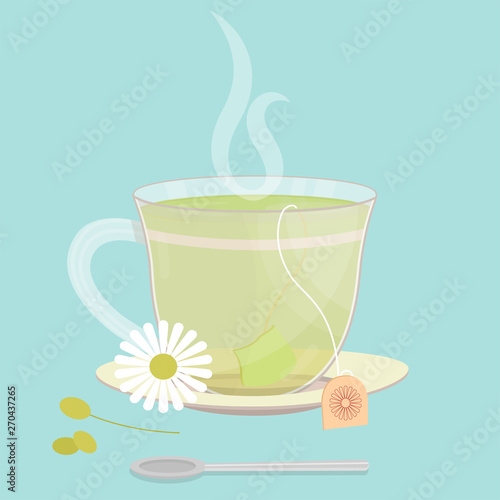 Cup of chamomile tea. Tea sachet with chamomile flower on the saucer. Smoke on the drink. Spoon in front of cup.