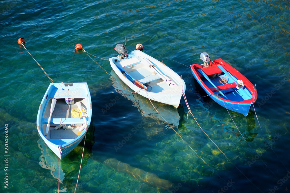Colourful boats in tiny marina of Riomaggiore, the largest of the five centuries-old villages of Cinque Terre, Italian Riviera, Liguria, Italy.