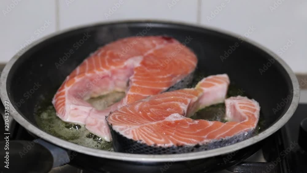 frying fresh salmon in frying pan frying fresh salmon in frying pan