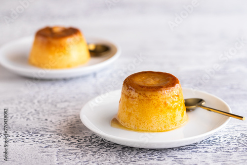 Flan dessert on the plate .Popular crème caramel dessert background with copy space...