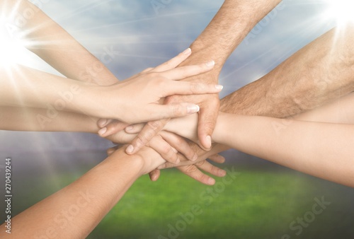 Family holding their hands together in shape on background