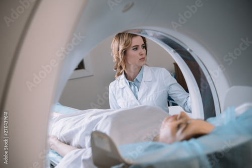 selective focus of attentive radiologist operating mri machine during patients diagnostics photo