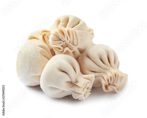 Pile of raw dumplings on white background