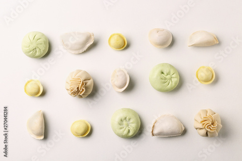 Composition with different dumplings on white background, top view photo
